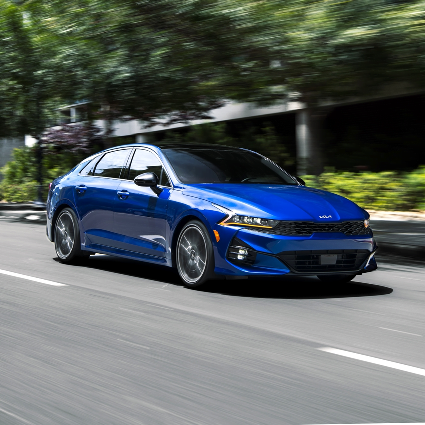 2023 Kia K5 GT driving down the road