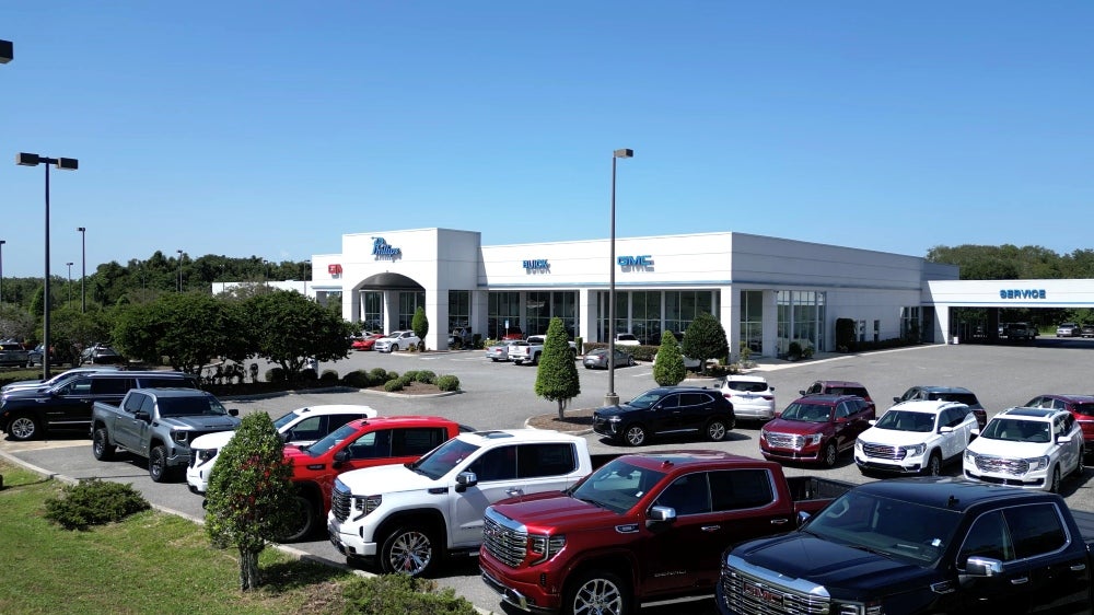 Phillips Buick GMC Fruitland Park dealership. Exterior image with rows of GMC Sierra Trucks
