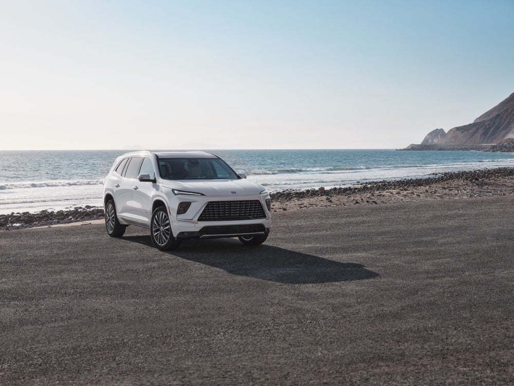White 2026 Buick Enclave Avenir parked on a beach