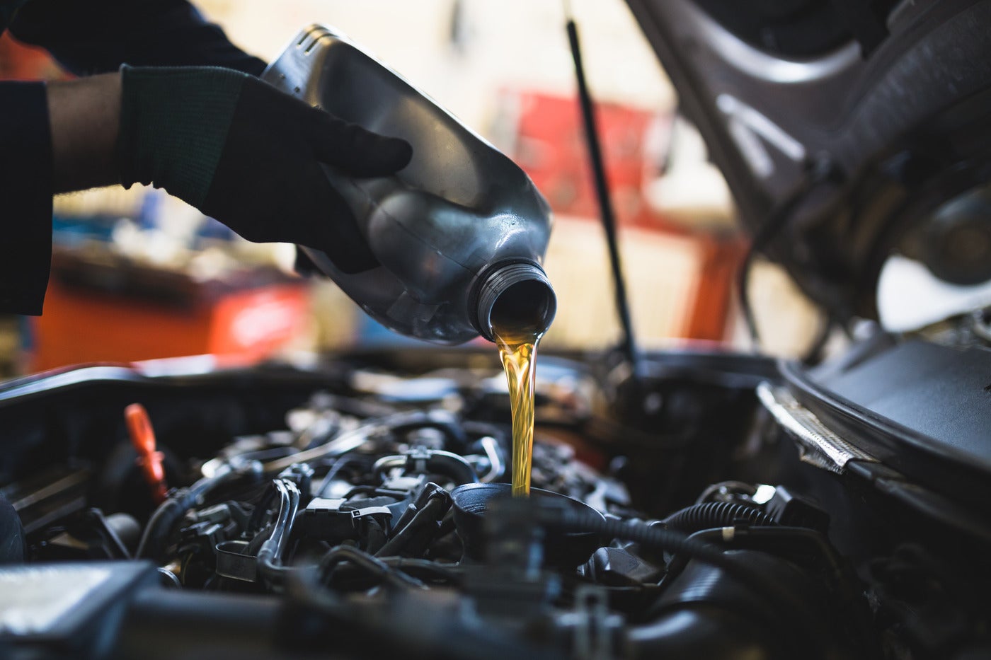 Mechanic Adding Oil to an Engine