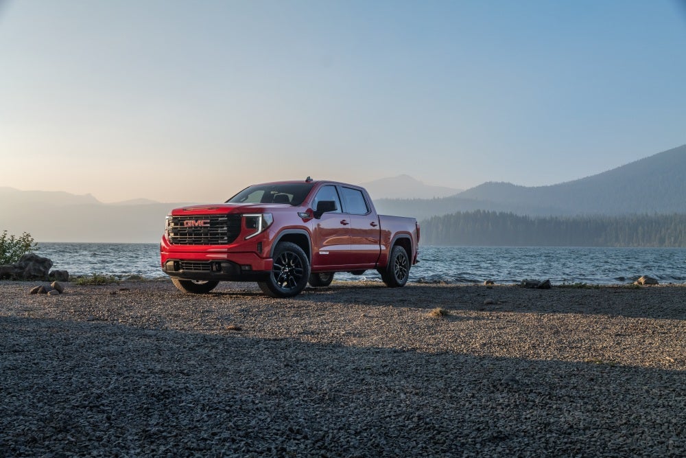 Red 2026 GMC Sierra 1500 Elevation parked next to a lake