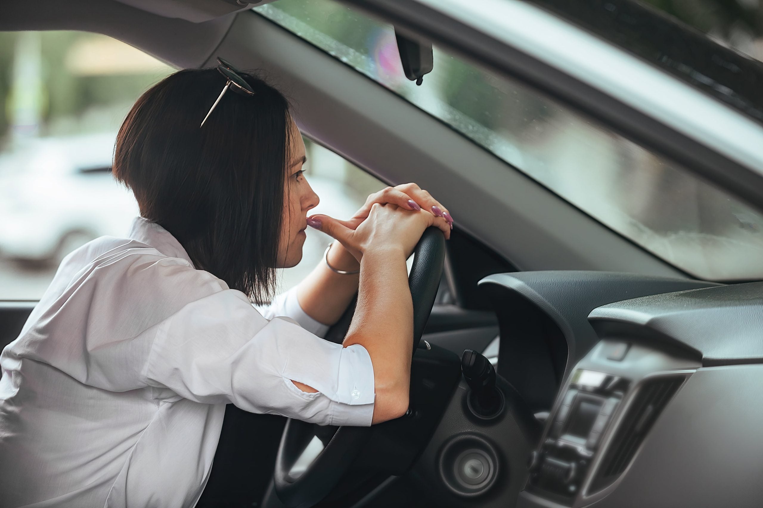 frustrated woman with a car that won't start