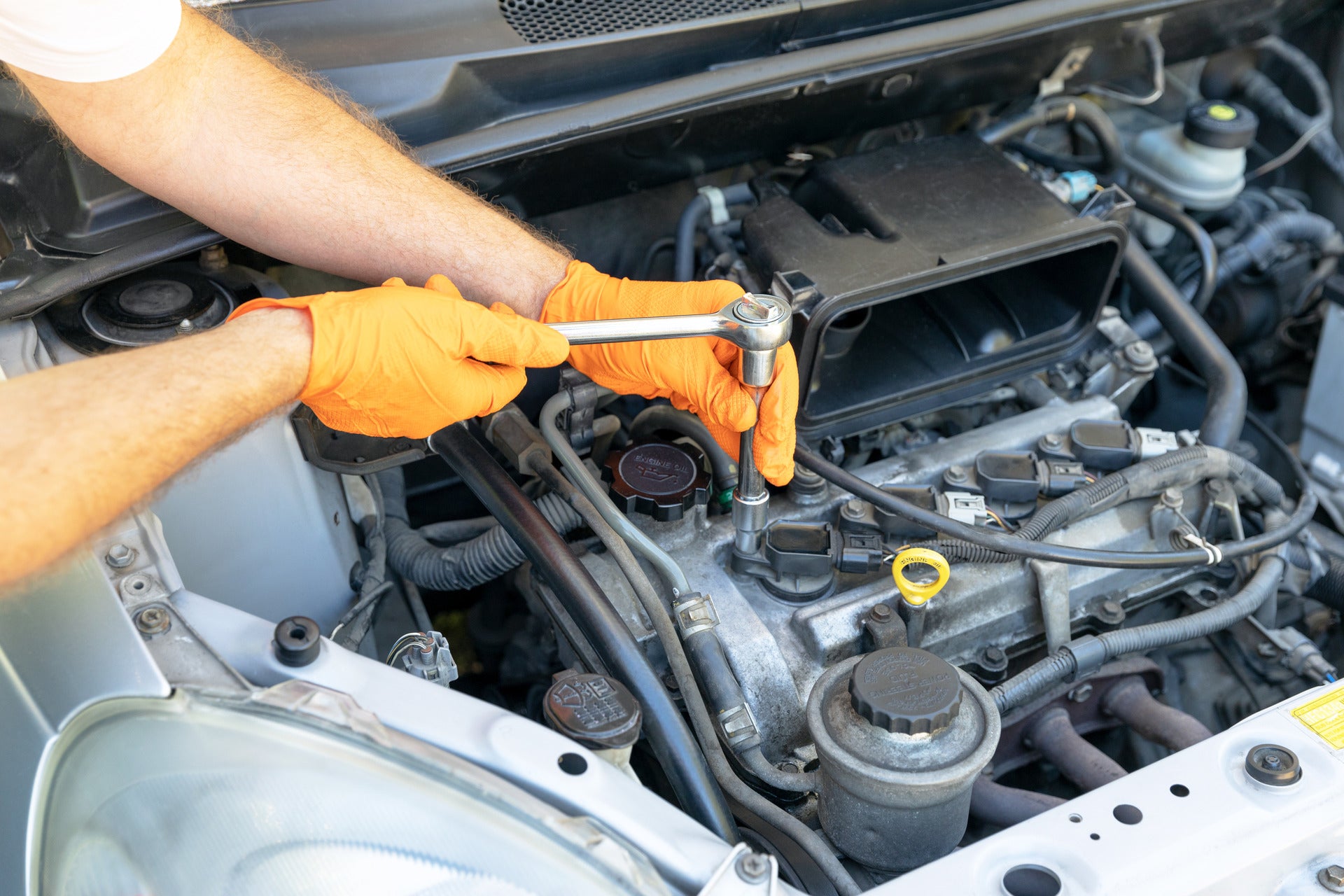Man replacing the sparkplugs in an engine