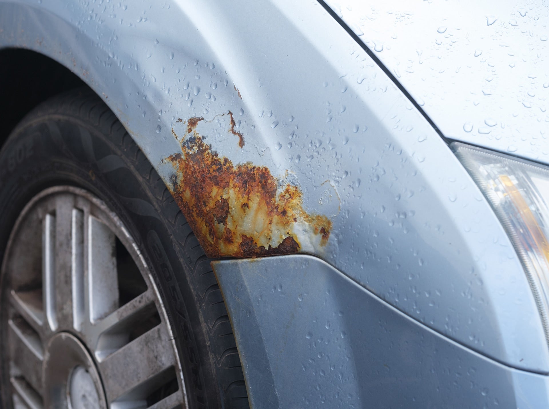 paint oxidizing with some rust damage on a car's wheelwell