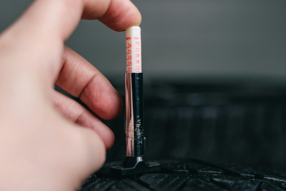 Technician inspecting tire tread depth