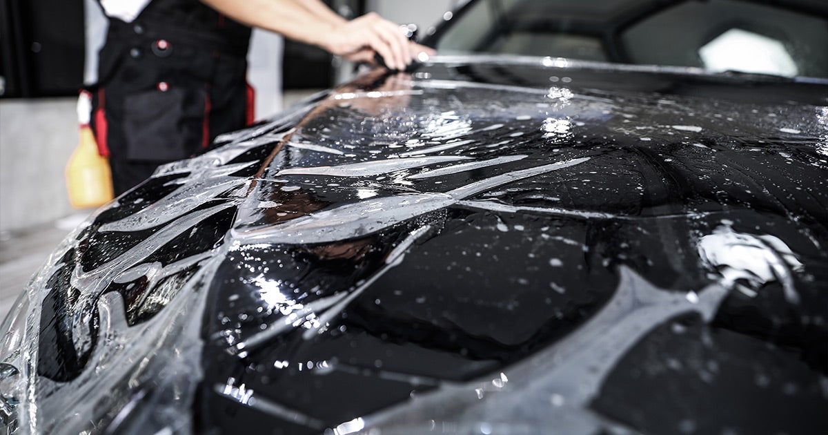 Black Honda with water droplets during professional detailing and paint protection service at Priority Honda Roanoke
