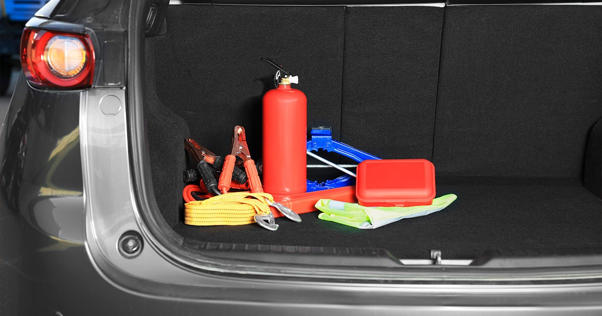 Alt text: Honda SUV trunk safety kit with jumper cables, fire extinguisher, jack, and emergency vest - Priority Honda Roanoke