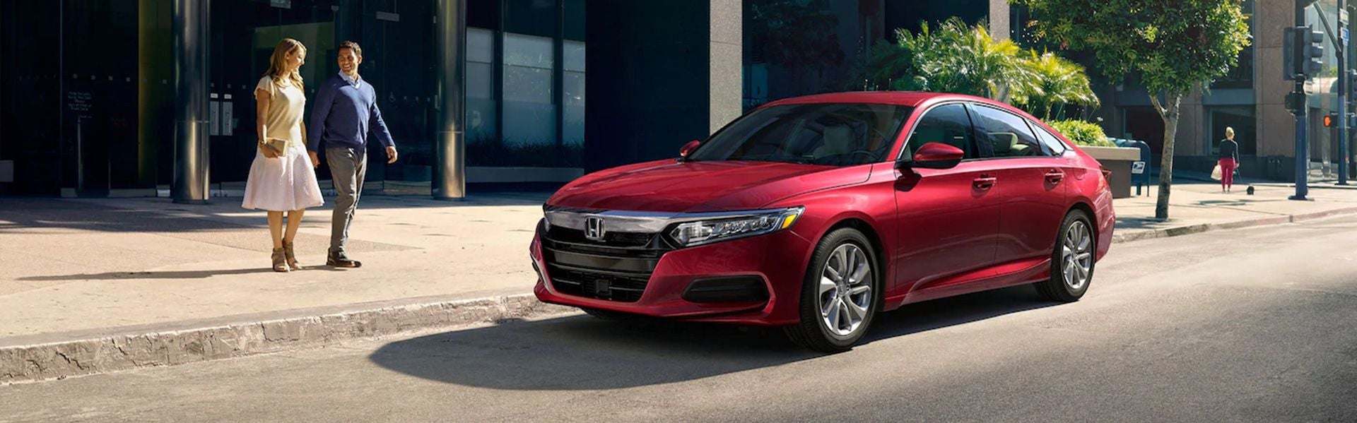 Red 2020 Honda Accord sedan parked on city street near modern building, Priority Honda Roanoke's stylish midsize sedan