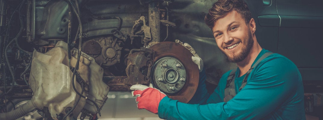 Mechanic performing service to make brakes last longer