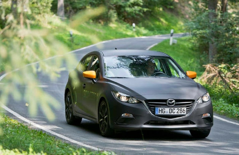 2019 Mazda3 driving down the road.
