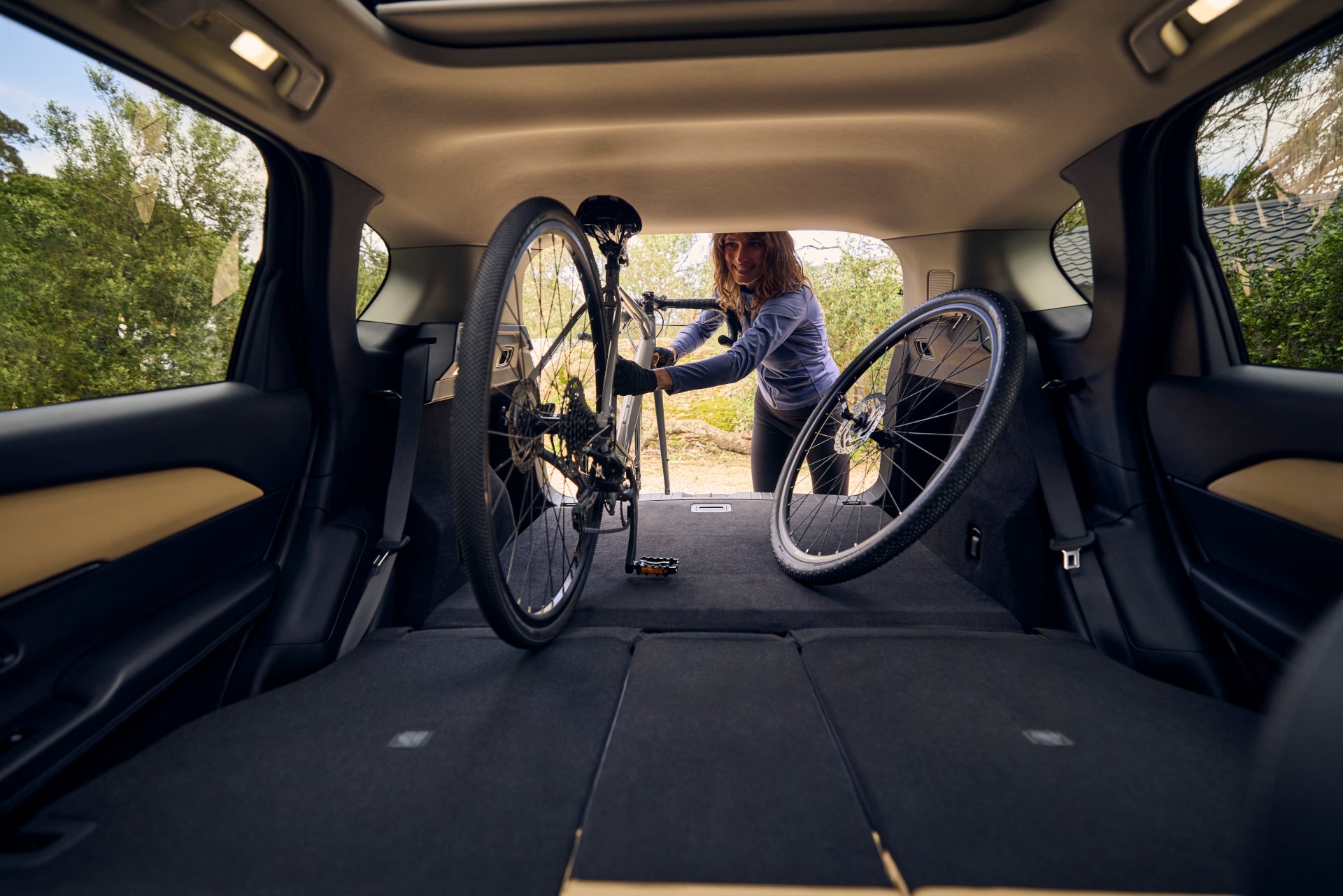 Cargo area of the 2026 Mazda CX-5 with rear seats folded flat and a bicycle loaded inside