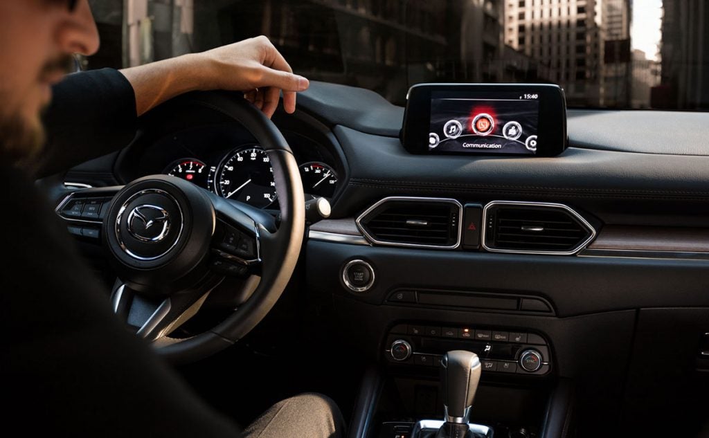 A man in a Mazda vehicle