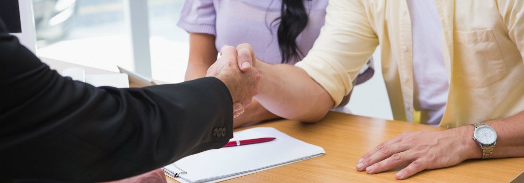 Close-up-of-car-salesman-shaking-hands-with-customer