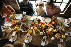 Family and friends sitting down for Thanksgiving dinner_b