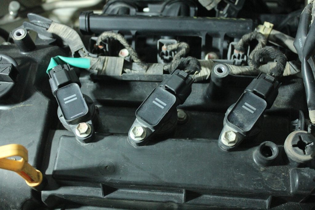 Ignition coils attached to a car engine in Dickinson, ND