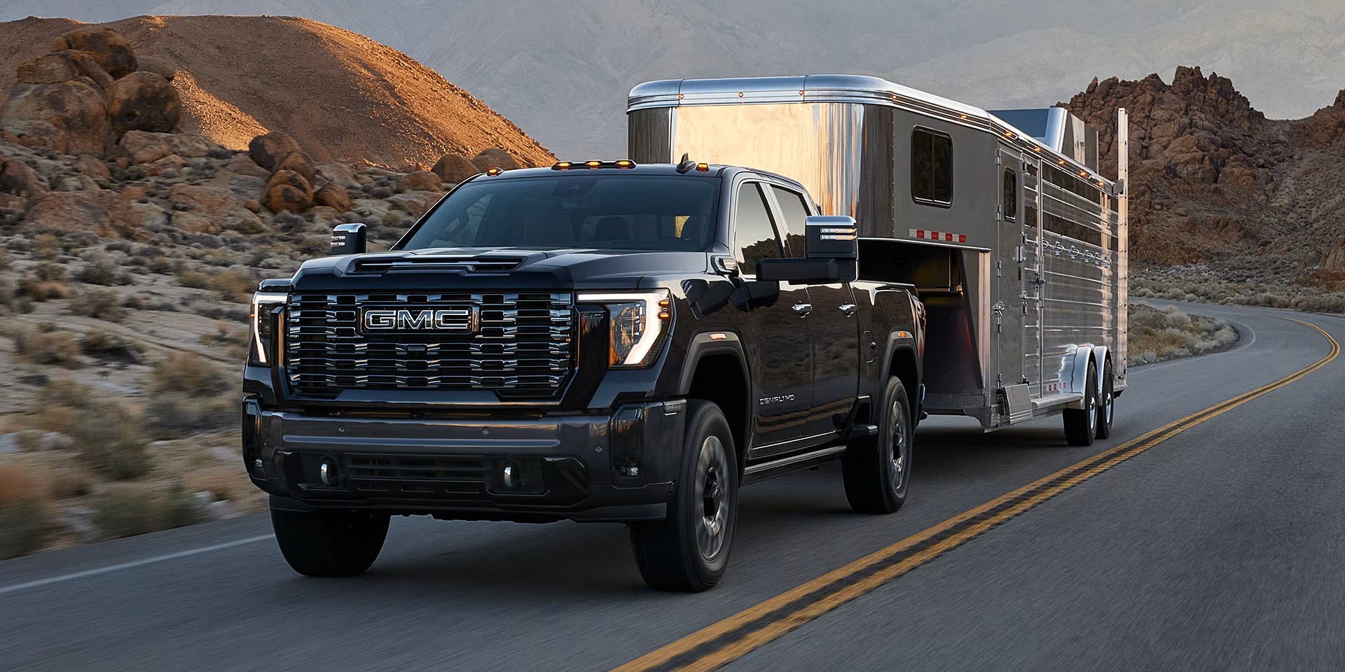 2026 GMC Sierra towing a large horse trailer