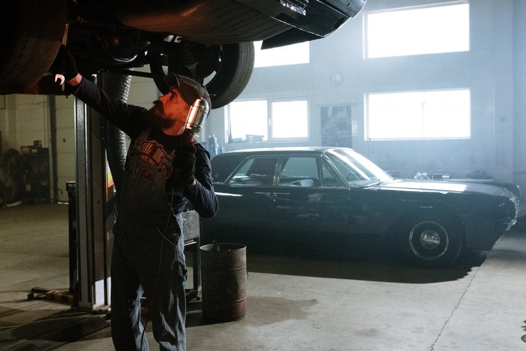 Certified Ford technician working on a Ford catalytic converter.
