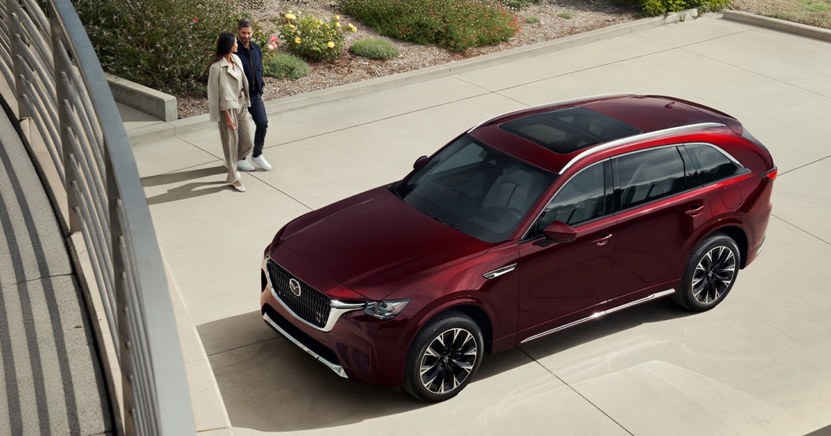 A Mazda CX-90 parked in the owner's driveway.