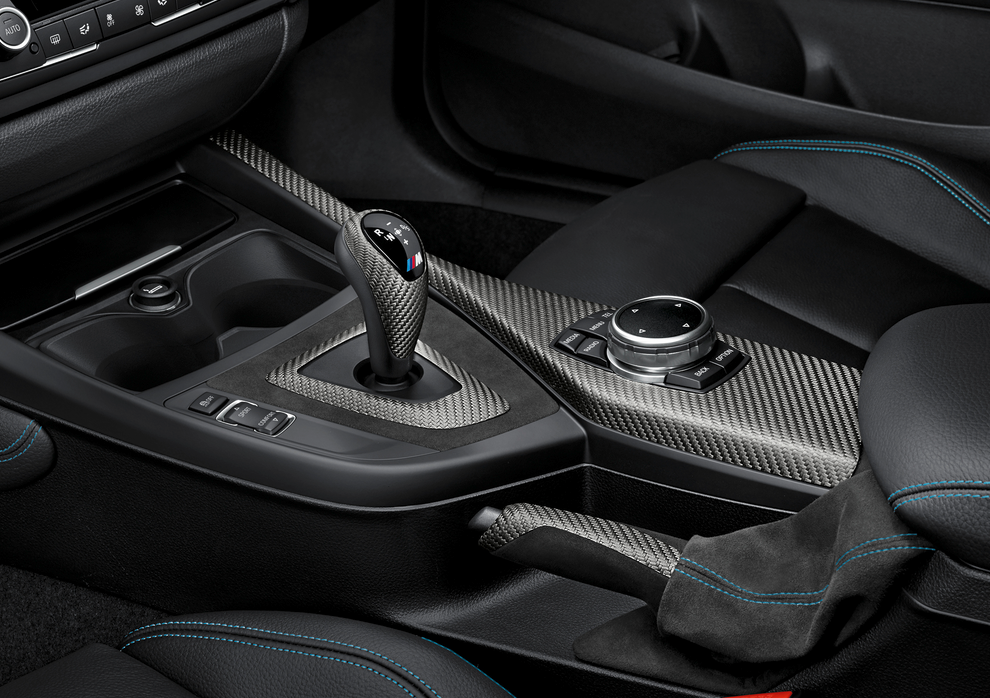 Genuine BMW Accessories carbon fiber center console cover.