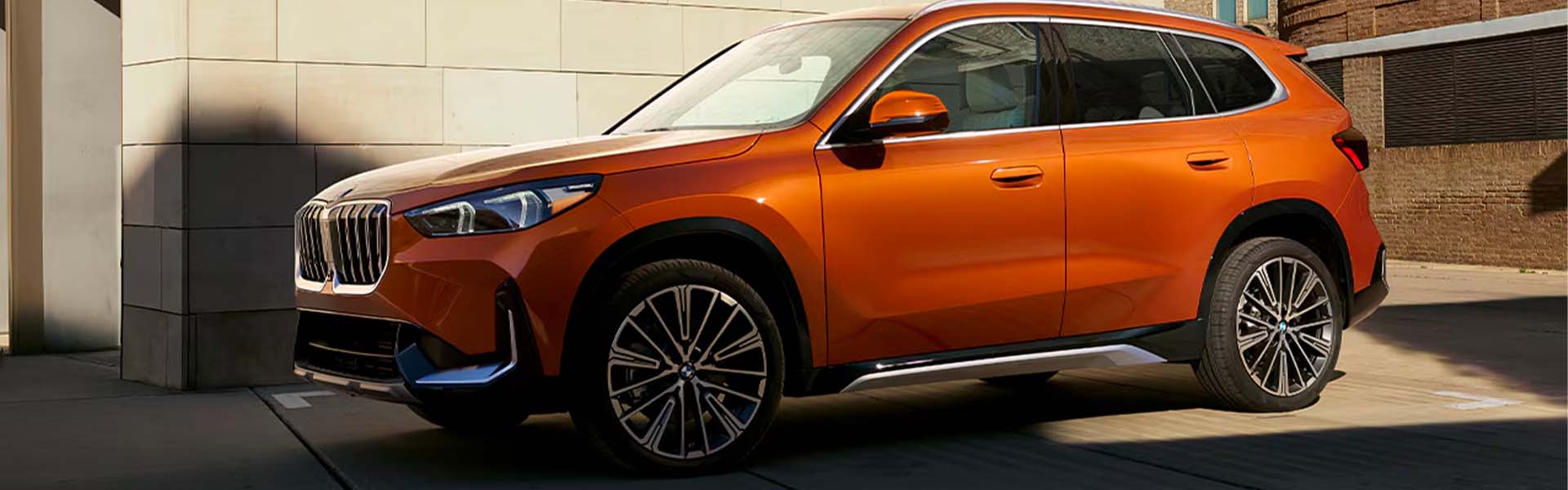 An orange 2025 BMW X1