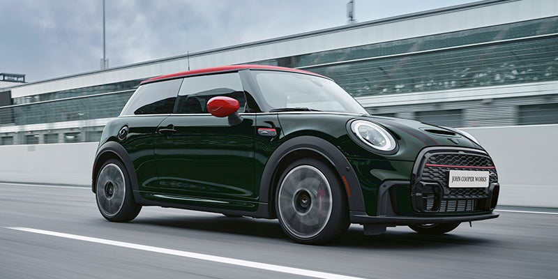 A MINI Certified Pre-Owned Cooper cruising on a racetrack.