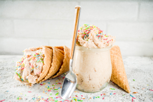 Ice cream with sprinkles on a cone and in a cup