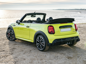Rear left view of yellow MINI Cooper on beach