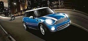 Blue MINI driving down the street