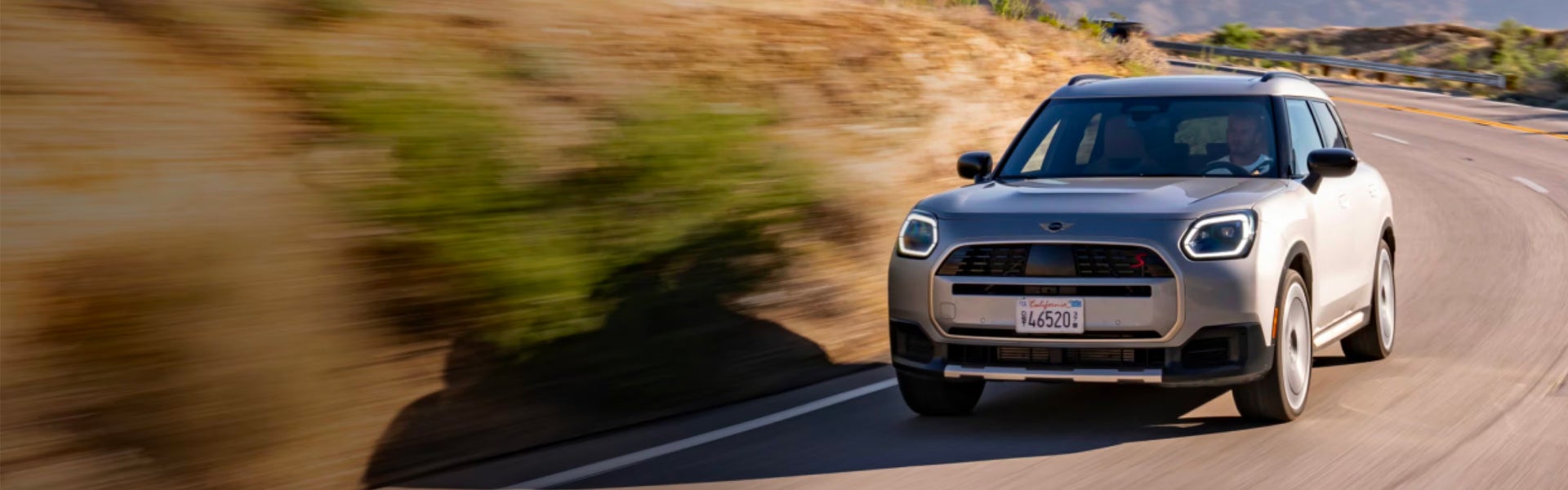 2025 MINI Countryman JCW ALL4 driving on a mountain road