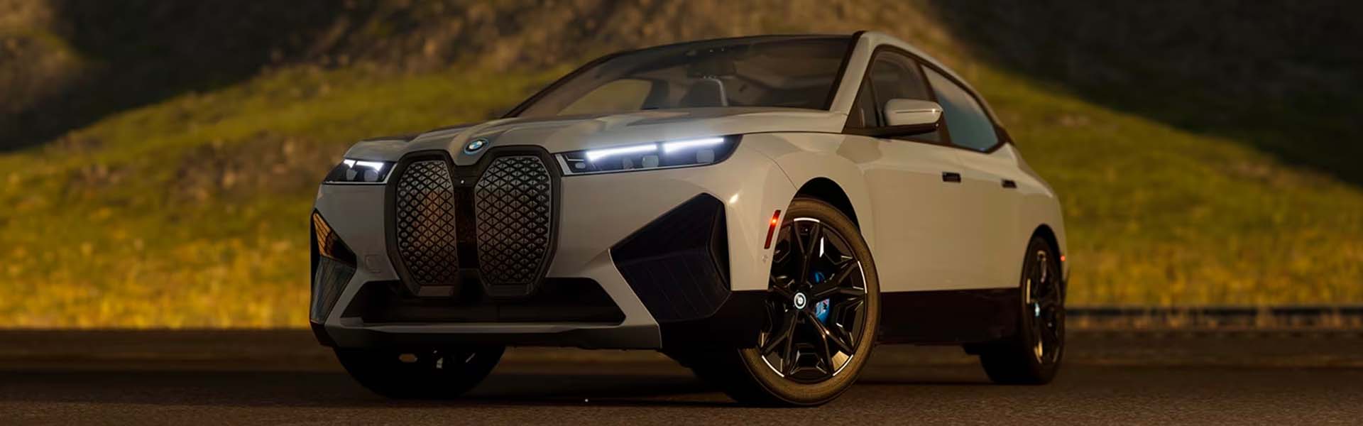 A white 2025 BMW iX at dusk