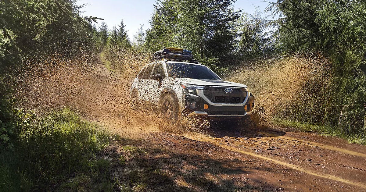 A Subaru Forester Wilderness driving through mud