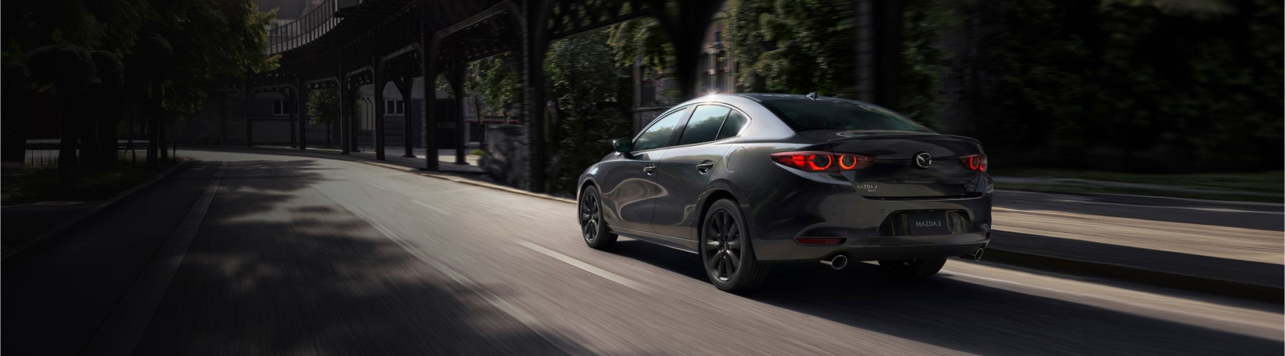 2025 Mazda3 driving on a city street.