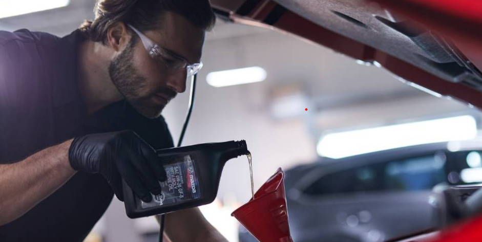 A Certified Mazda Technician performing an oil change