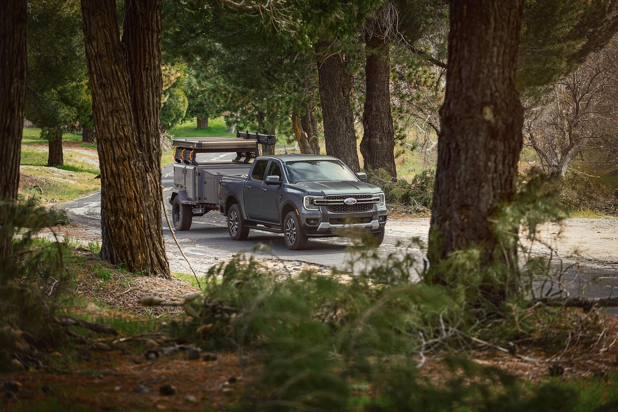 2026 Ford Ranger pulling a large trailer on a paved road