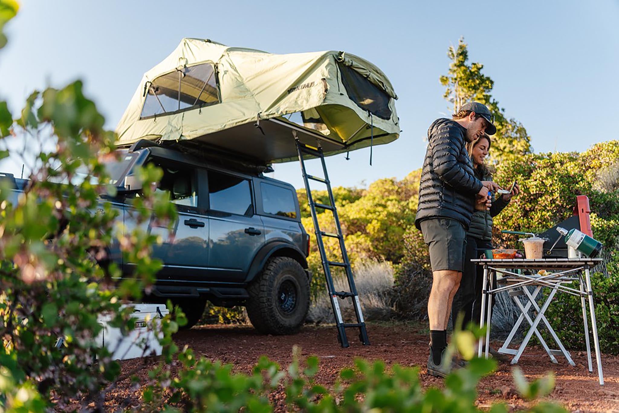 Ford Bronco parked at a campsite with a rooftop tent, the kind of trip that depends on a healthy battery