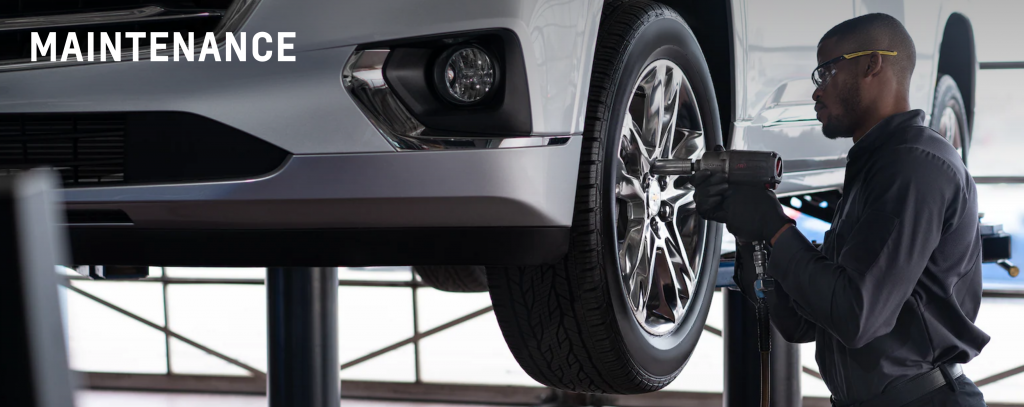 A service technician is installing a tire at the dealership service center