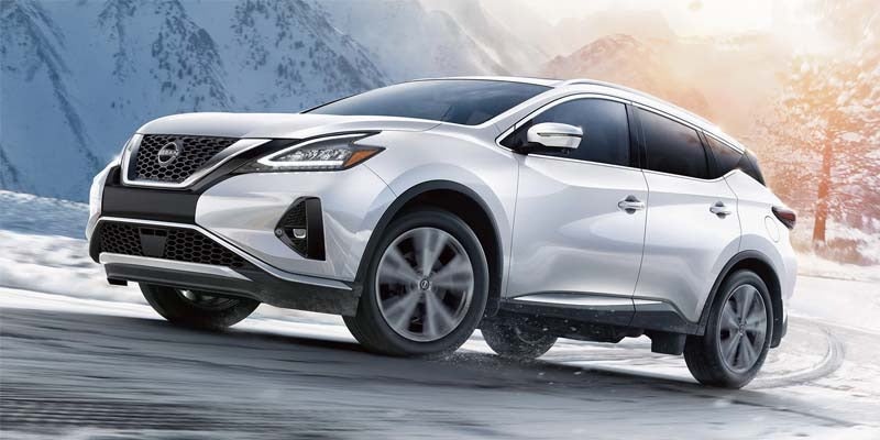 A 2024 Nissan Murano driving up a snowy hill in Medina, OH