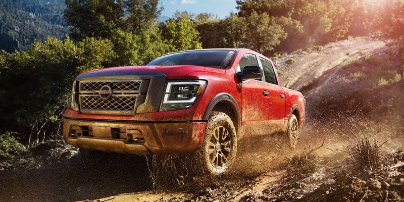The versatile 2024 Nissan TITAN powering through mud near Medina, OH
