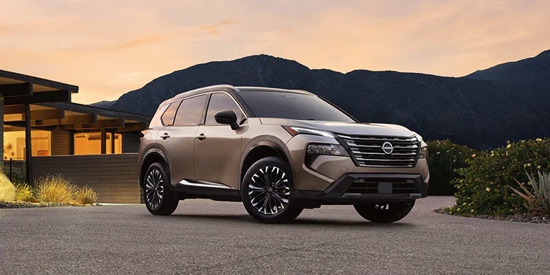 A 2024 Nissan Rogue parked outside a stylish house near Medina, OH