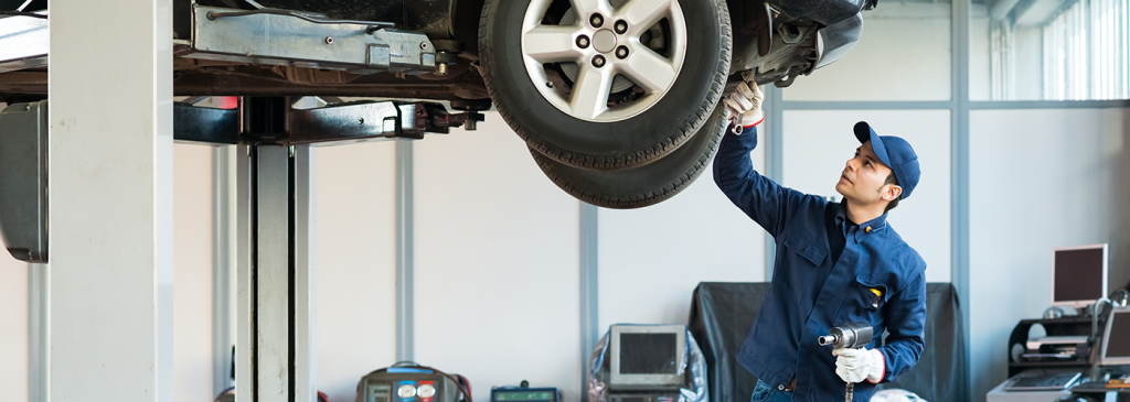 A Nissan technician checking the tires on your Nissan in Mayfield Heights, OH