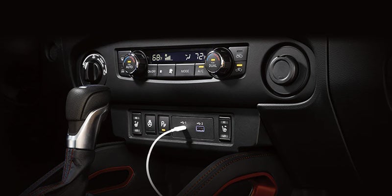 A 2024 Nissan Frontier charging a phone with its healthy battery in Mayfield Heights, OH