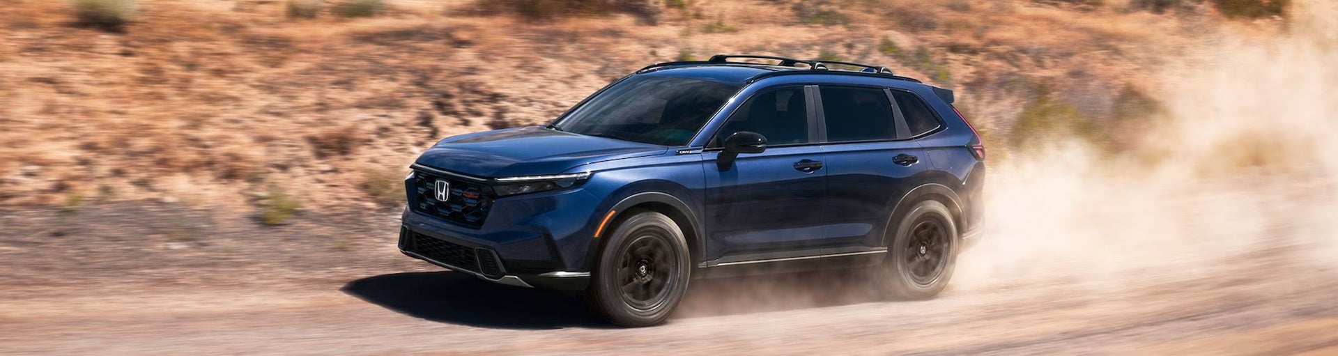 A blue Honda CR-V driving off-road.