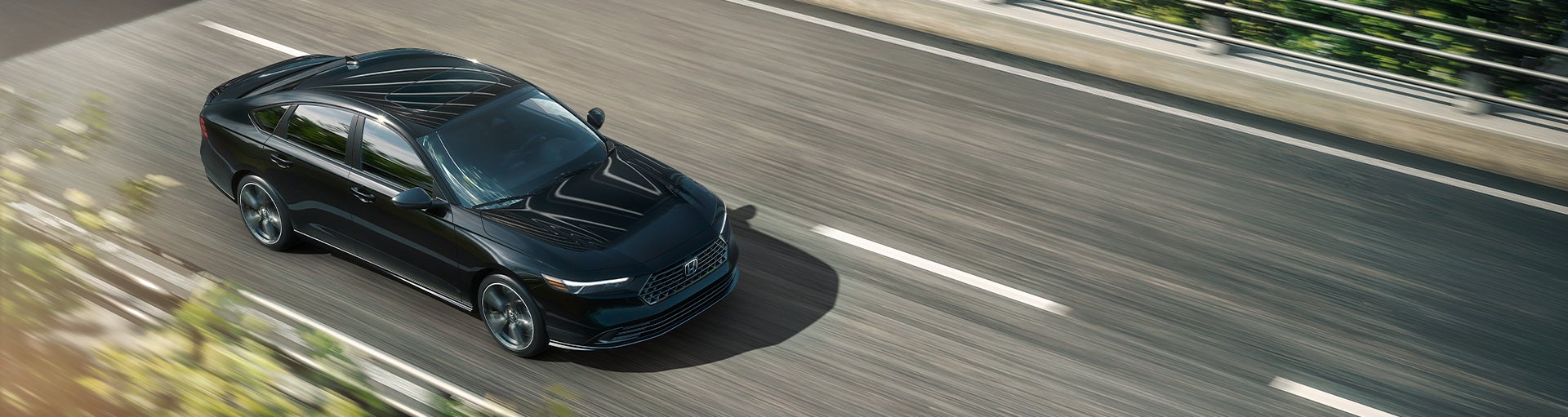 A Honda Accord midsize sedan in black driving along a multi-lane highway from an elevated overhead perspective.
