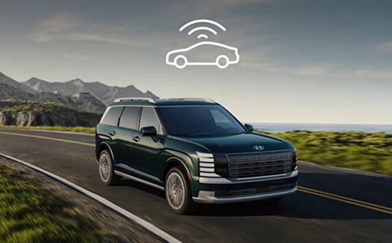 A Hyundai Palisade driving along a coastal road with a Wi-Fi signal icon above it