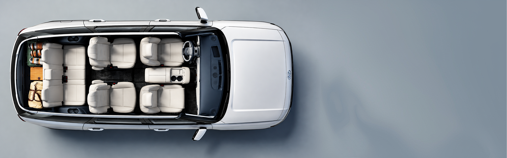 Overhead cutaway of a white Palisade showing all three rows of seats and luggage in the cargo area