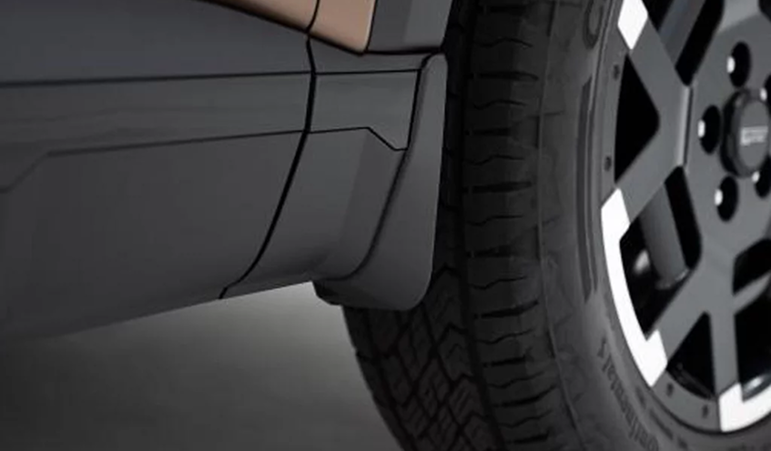 A black mud guard fitted behind the front wheel of a Palisade