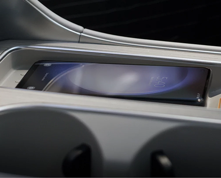 A smartphone on the wireless charging pad in the Palisade console