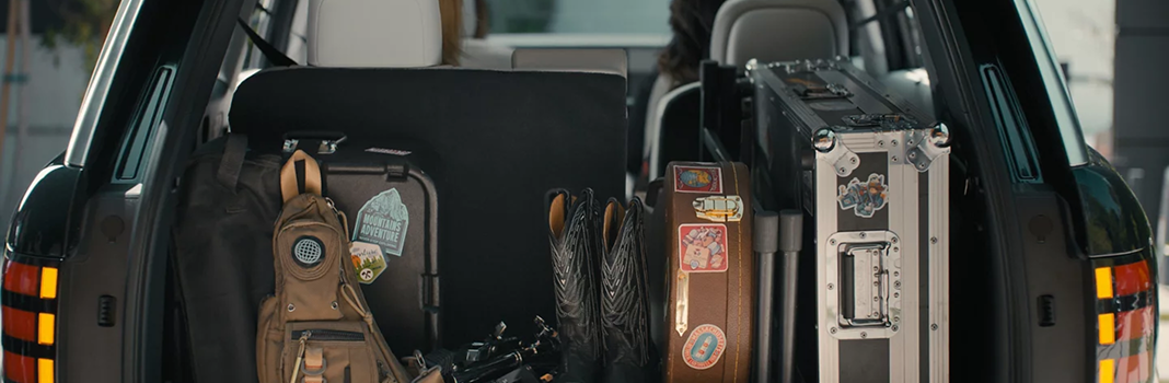 Guitars, luggage and gear packed in the open cargo area of a Palisade