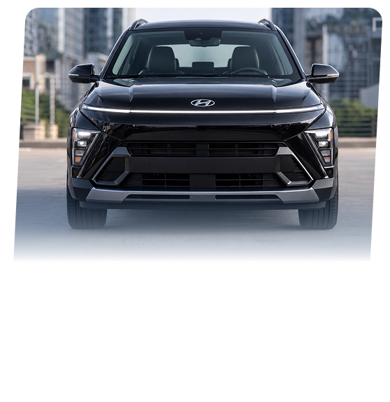 A black Hyundai Kona crossover seen head-on on a city street