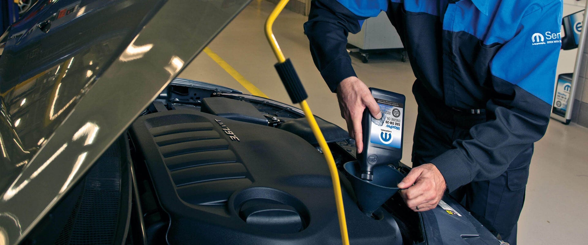 AN OIL CHANGE BEING PERFORMED ON A JEEP VEHICLE